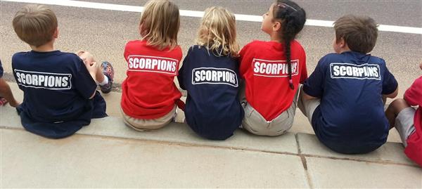 Students sitting down with shirts that say scospions