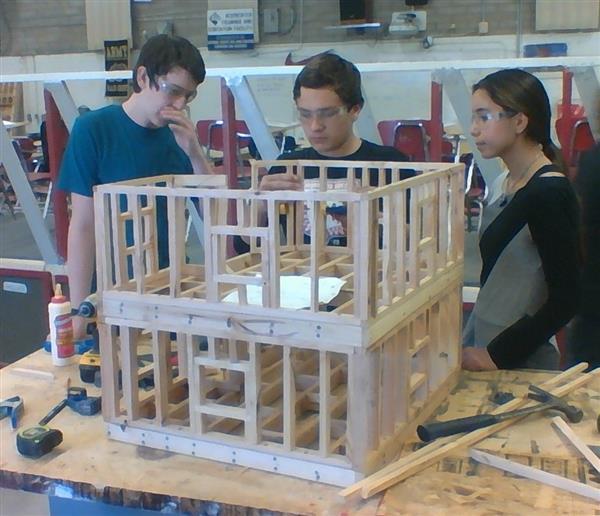 Construction students framing a structure.