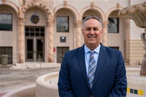 Dr. KC Sommers in front of Old Main