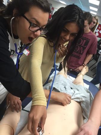 Medical Assisting students checking a patient's heartbeat. 