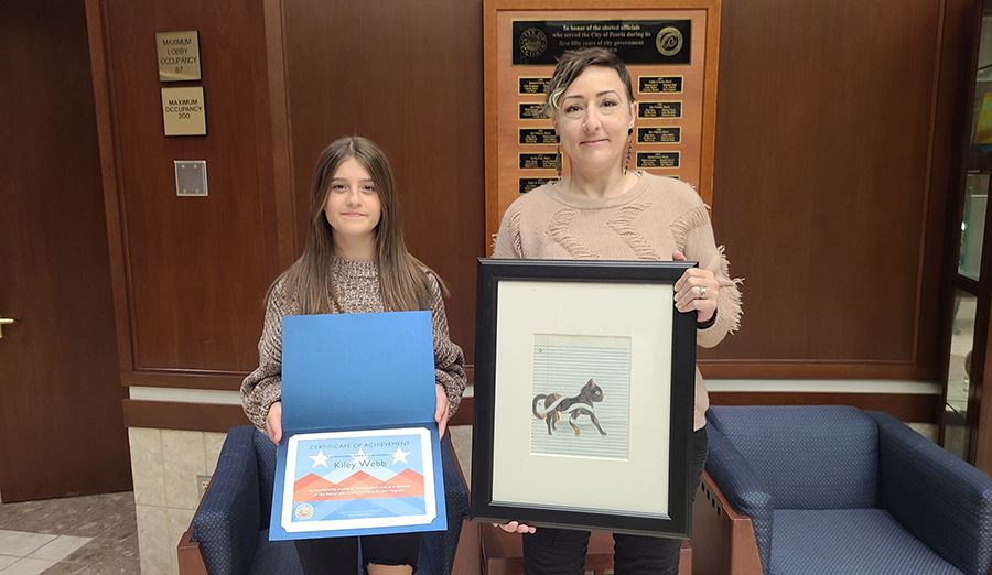  Award winning Peoria Unified student poses with her certificate and framed artwork