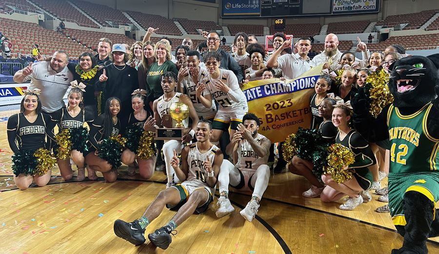  PHS basketball team celebrates on the court with supporters after winning the state title. 