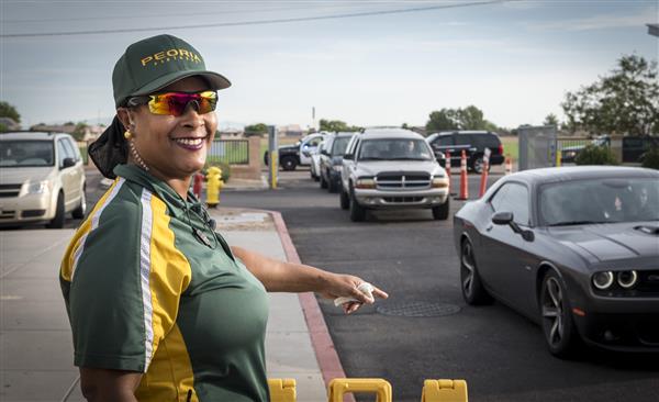 Smiling security guard directs traffic