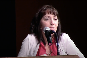 Lisa Armenta speaking at podium after winning award