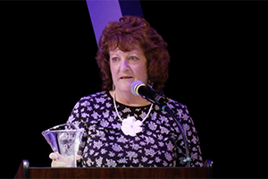 Kathy Fitzgerald speaks at podium after winning award