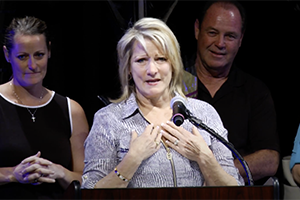 Renee Kotchka speaks at podium after winning award