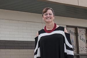 Brenda LoPresto standing in front of Peoria Elementary School