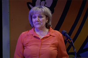 Carol Michael speaks at podium after winning award