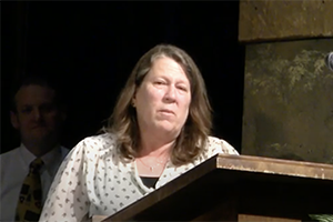 Barbara Troyky speaks at podium after winning award