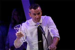 Michael speaks at podium after winning award