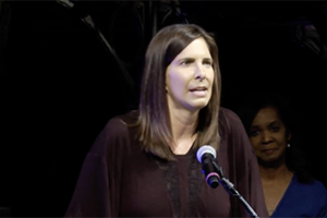 Kathy Wilson speaks at podium after winning award